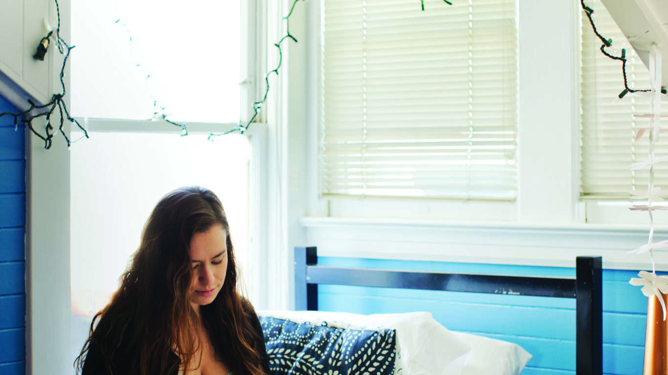 Girl Sketching on Top of Bed