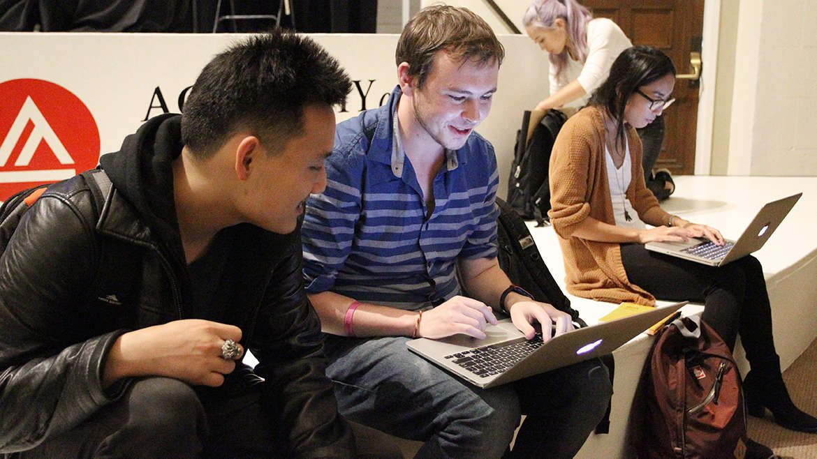 Students Sitting on Platform with Laptops