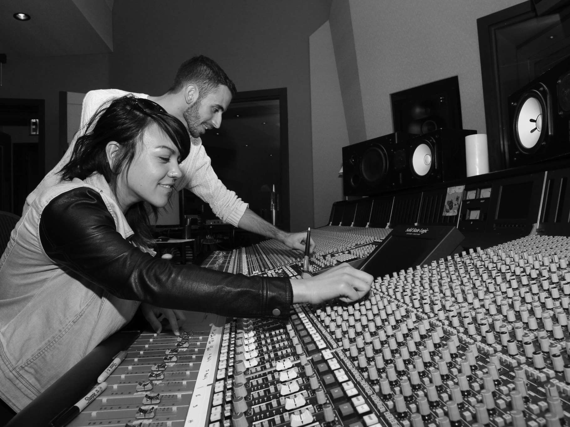 Students inside music production booth