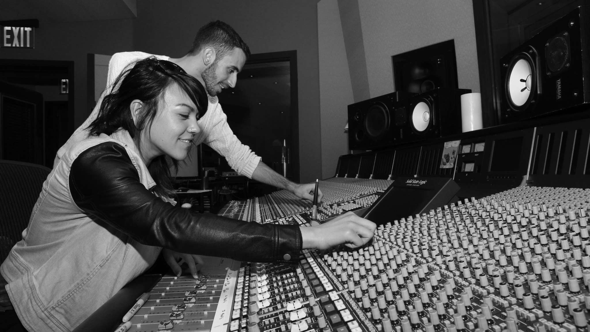 Students inside music production booth