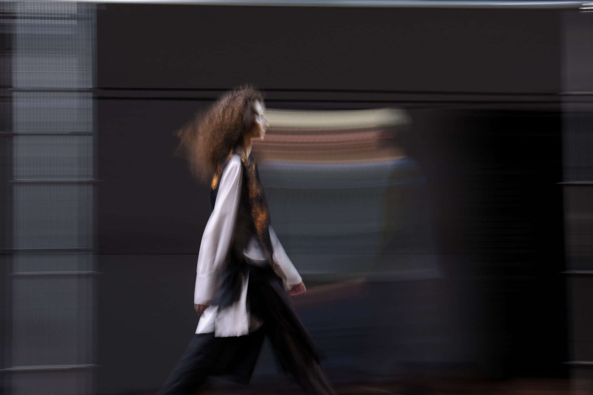 model walking down fashion runway in profile