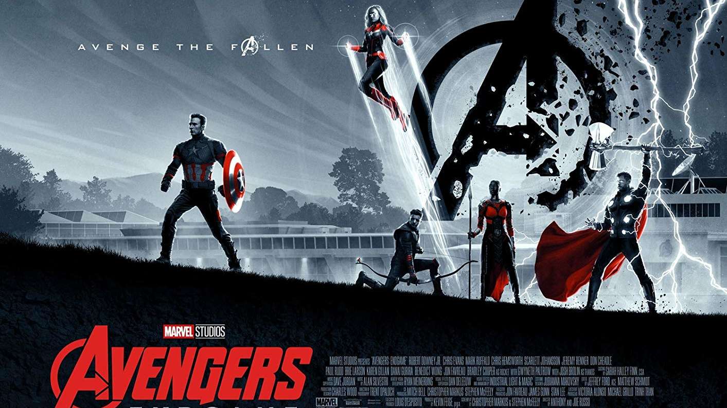 An image of the Avengers standing in a field, left to right: Captain America, Captain Marvel, Hawkeye, Okoye, and Thor