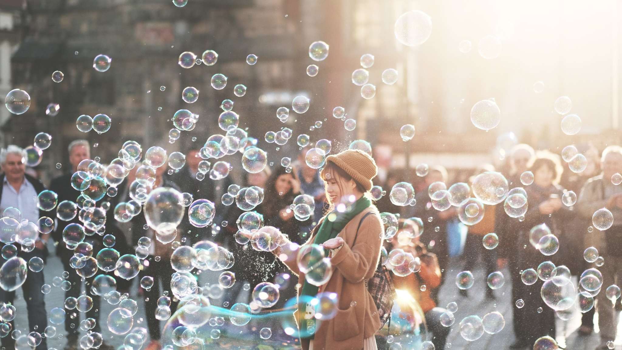 Woman in crowd surrounded by bubbles