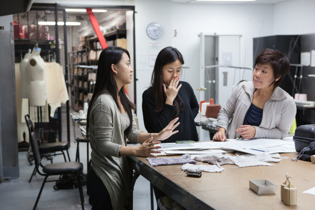 Fashion students collaborating with teacher