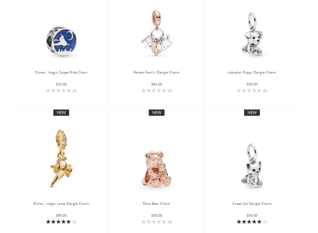 Six charms: a genie's lamp charm, a magic carpet charm, a teddy bear charm, a cat charm, a dog charm, and a charm that reads "family"