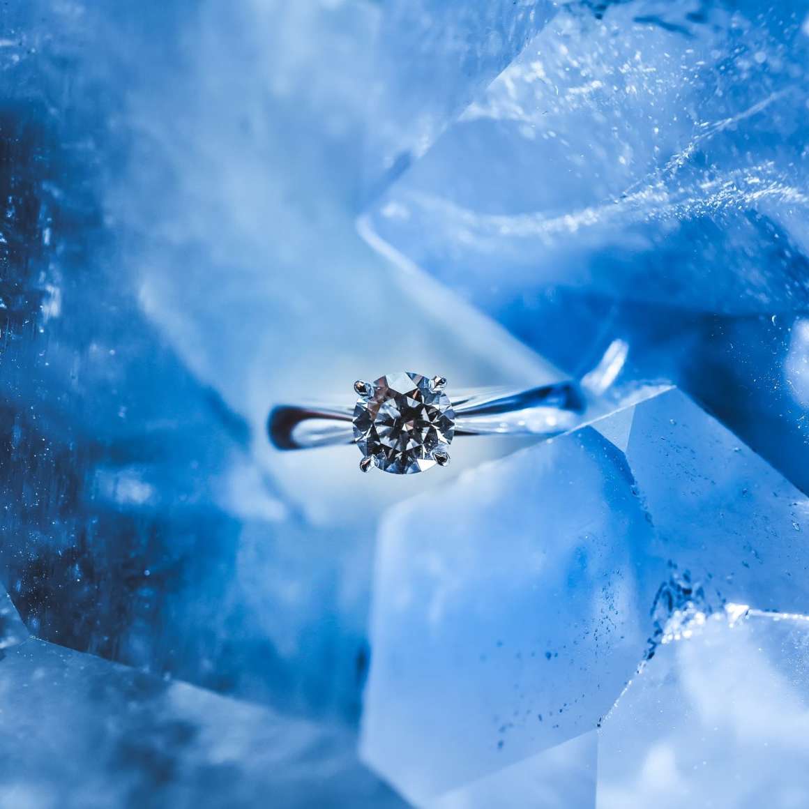 silver diamond ring on a blue hunk of ice