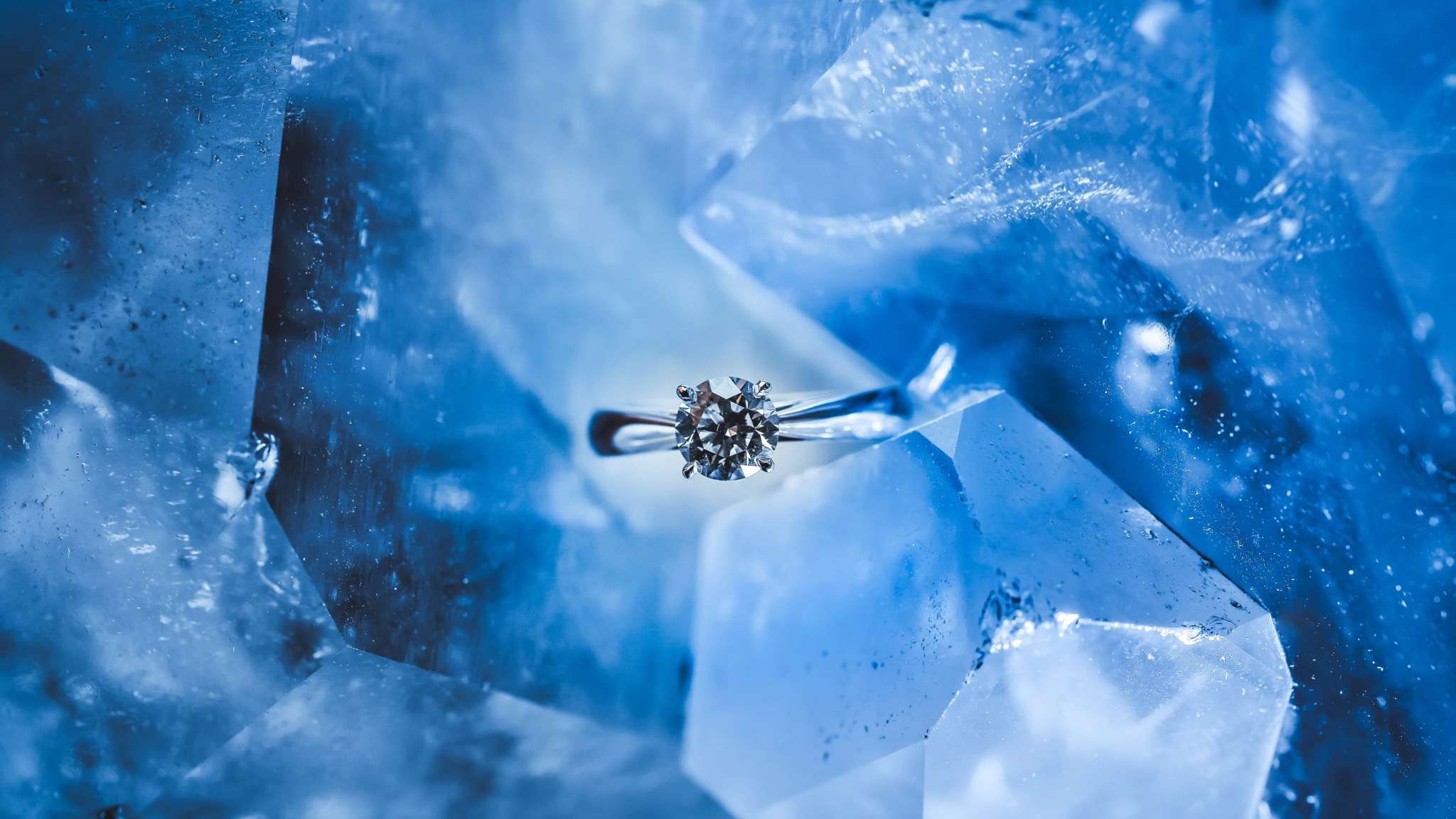 silver diamond ring on a blue hunk of ice