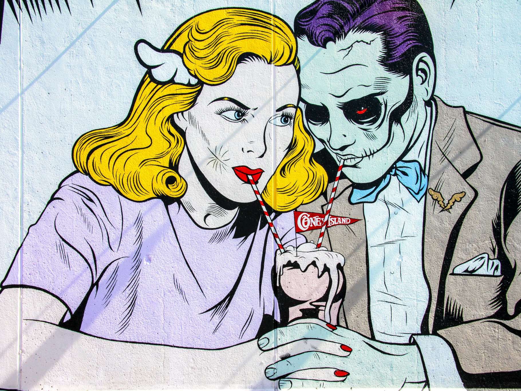 A comic book style man and woman sharing a milkshake