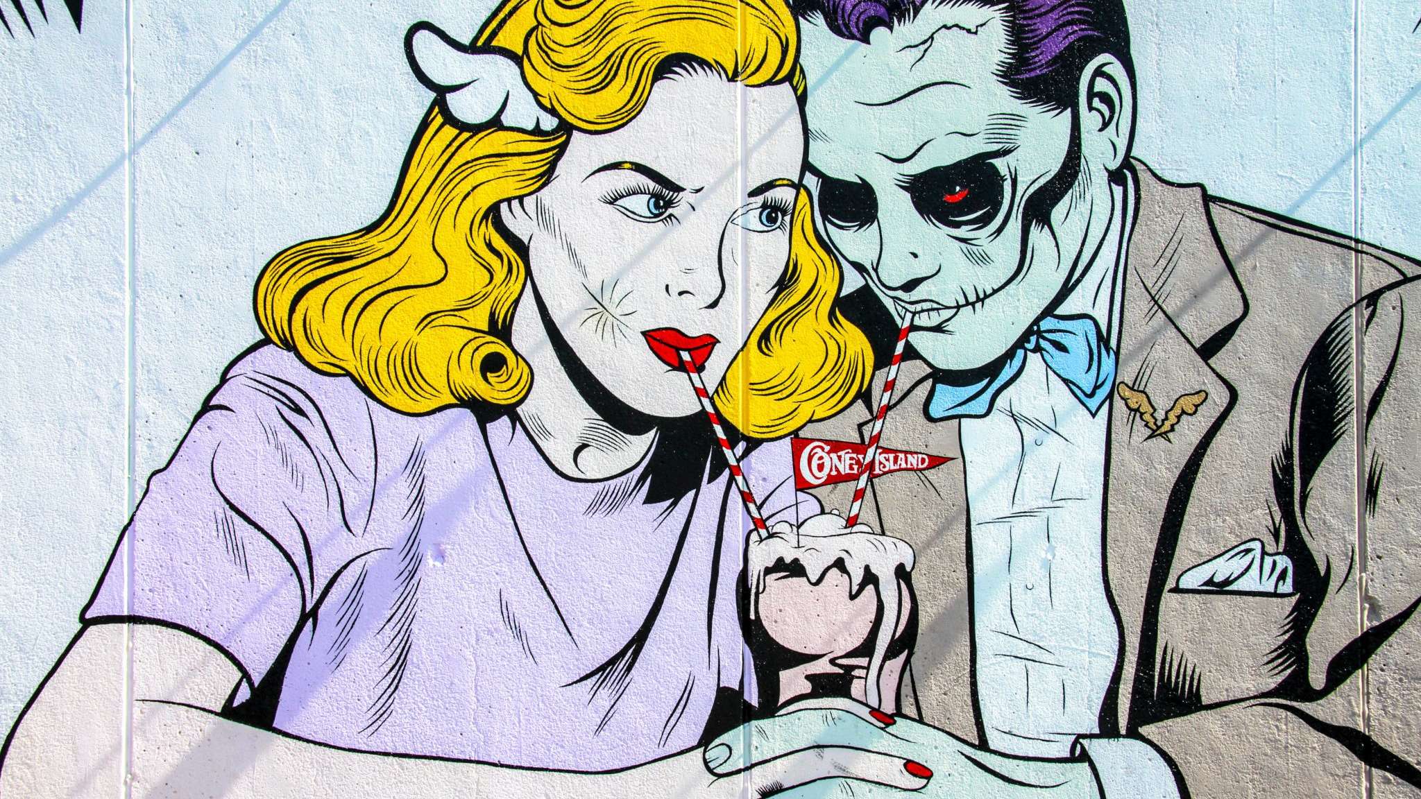 A comic book style man and woman sharing a milkshake