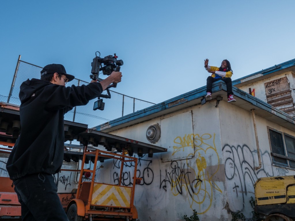 man filming a person on the roof