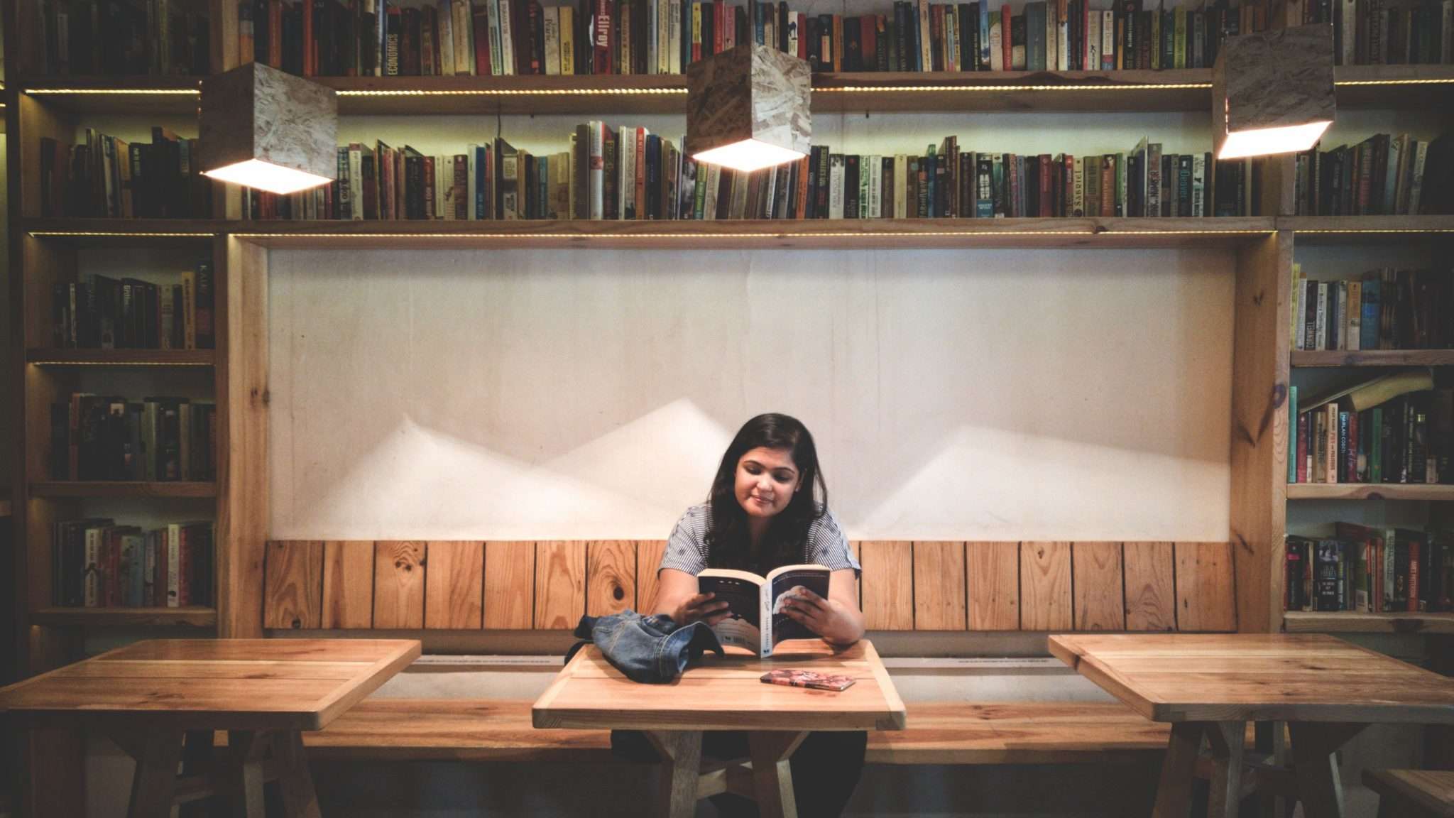 student reading alone in library