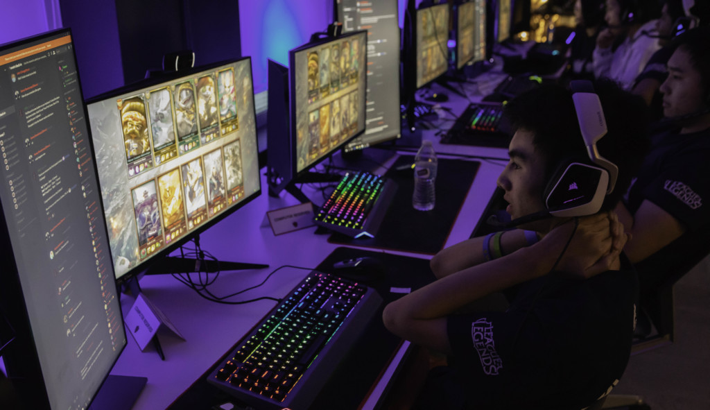 Academy game development student playing video games on computer