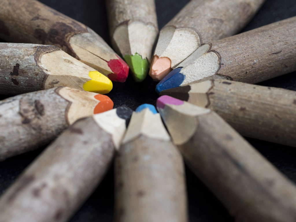 Rough, wooden, sharpened colored pencils in a circle, touching at the top