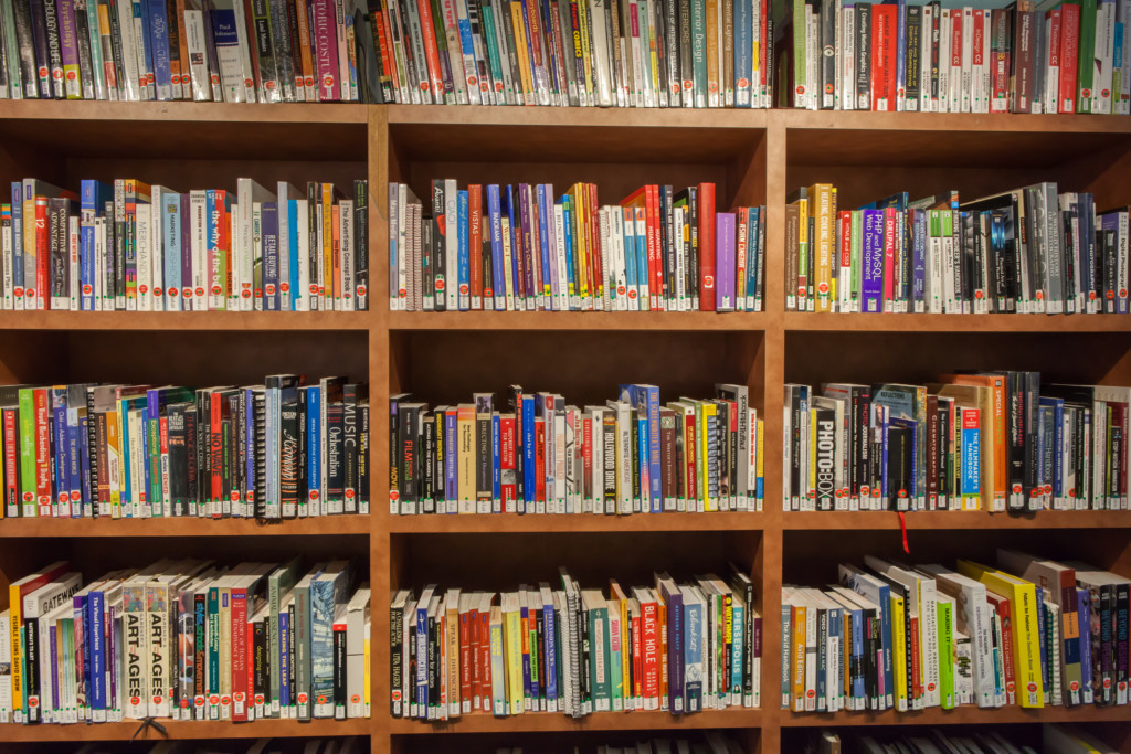 Large bookshelf filled with colorful books of all shapes and sizes