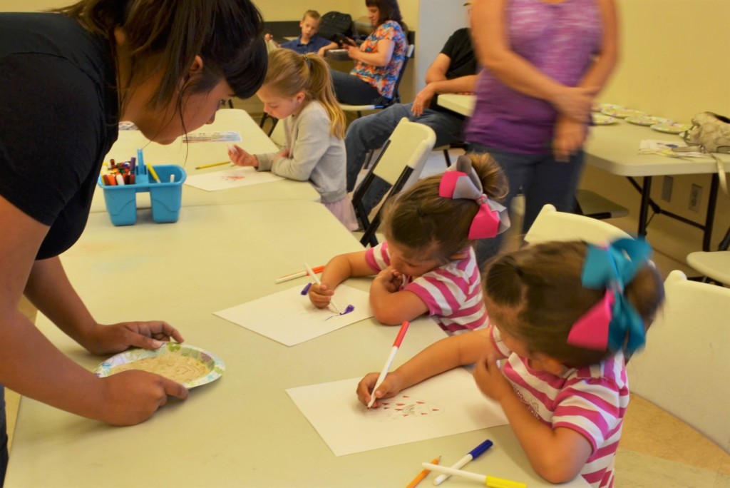 Teacher teaching art to young children